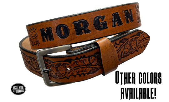 The Tall Oak Name Leather Belt is crafted from strong, high-quality Veg tan leather with an embossed Oak and Acorn pattern. Choose your finish and a name if desired. Its solid Antique nickel brass buckle is easy to change with included snaps, perfect for everyday wear. Handmade outside of Nashville in Smyrna, TN.